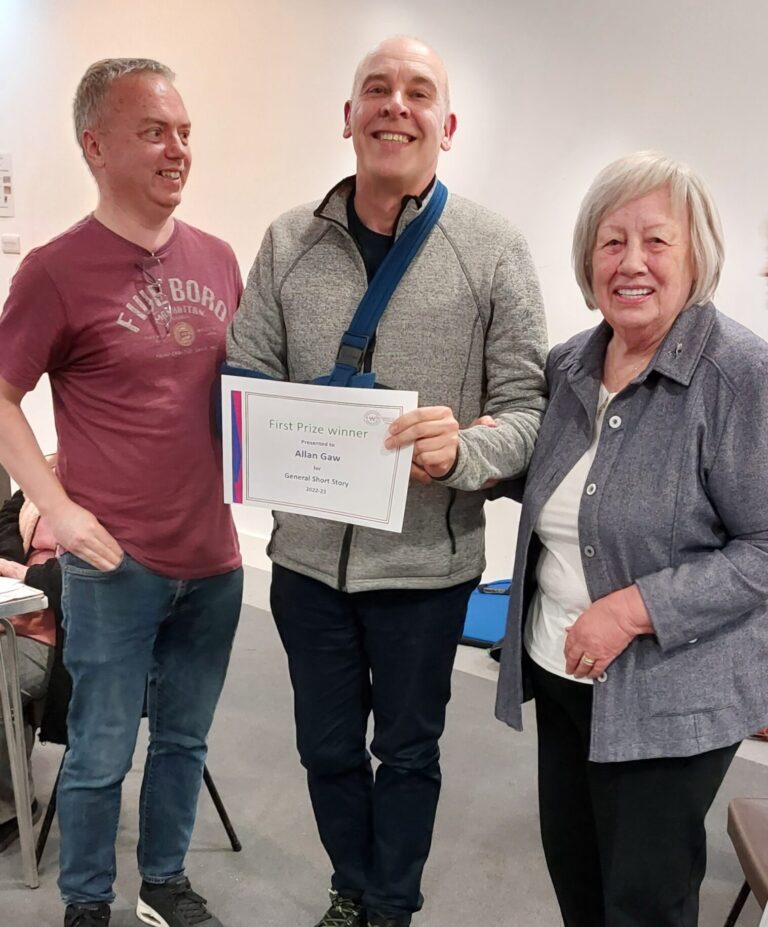Allan Gaw is presented with a certificate for first prize in the General Short Story. He is shown with adjudicator, Andy Raffan and Competition secretary, Adrienne Whitehall.
